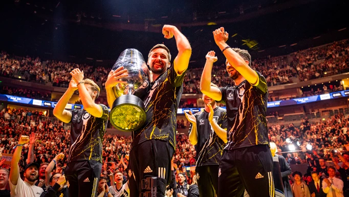 hooxi holding trophy with team on stage