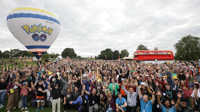 Many fans in front of the Pokemon GO Balloon and Pokemon Bus